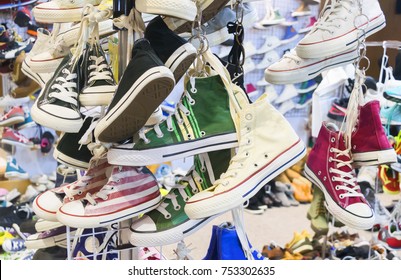 Sneakers Shoes Background. Colorful Fashion Mens Sneakers Hanging In A Shop Display With Others Shoes On Shelf Background

