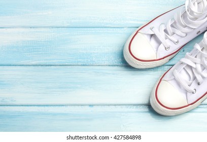 sneakers shoes wood background gentle blue tone