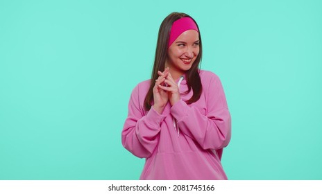 Sneaky cunning teen stylish girl with tricky face gesticulating and scheming evil plan, thinking over devious villain idea, cunning cheats, jokes and pranks. Young one woman on blue studio background