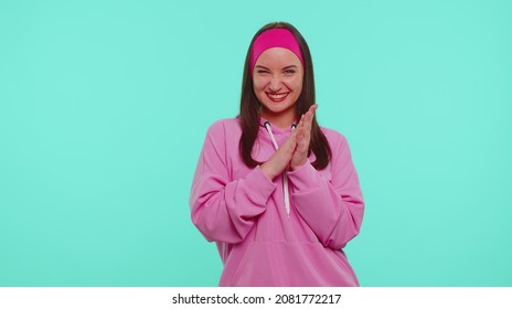 Sneaky cunning teenager stylish girl with tricky face gesticulating and scheming evil plan, thinking over devious villain idea, cunning cheats, jokes and pranks. Young woman on blue studio background