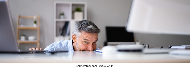 Sneaky Mature Man Avoiding Work In Office