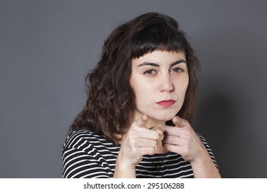 Sneaky Young Brunette Woman Staring At Someone With Index Fingers Forward Accusing And Denouncing Someone With Half Closed Eyes