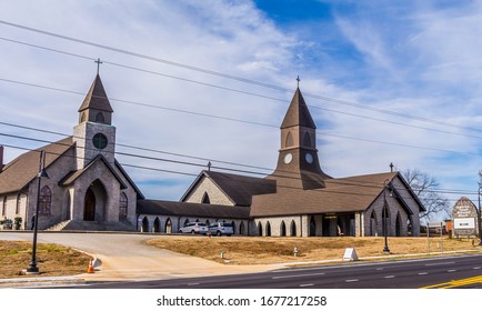 Snellville, GA / USA - March 8 2020: Front Main Street View of the Snellville United Methodist Church, showing the double steeples and the street sign