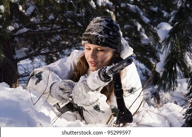 Sniper Girl In White Camouflage Aiming With Rifle At Winter Forest.