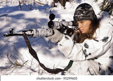 Sniper Girl In White Camouflage Aiming With Rifle At Winter Forest.