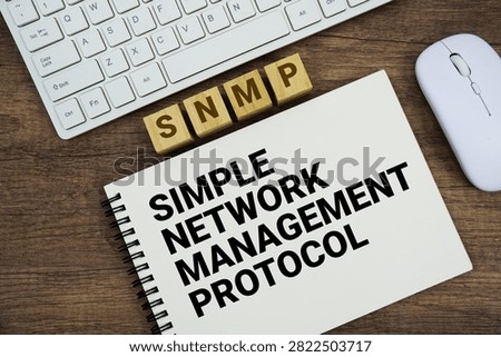 SNMP Simple Network Management Protocol message with keyboard and optical mouse on wooden background