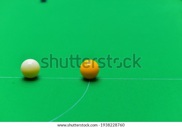 The snooker ball before the start of the game is\
located on the green table.