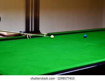 Snooker player placing the cue ball for a shot