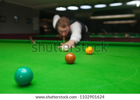 Snooker player ready for the shot. Background snooker club
