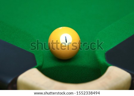 Snooker pool table hole at corner and ball number one 