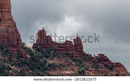 Snoopy Rock formation under a dramatic cloudy sky in Sedona, Arizona