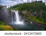 Snoqualmie Falls with lush greenery and mist in Washington State, USA. Snoqualmie Falls is a 268-foot waterfall on the Snoqualmie River between Snoqualmie and Fall City. Long exposure.