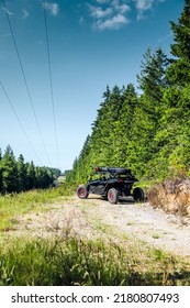 Snoqualmie, WA, USA 
June 20, 2022 
Canam Maverick Turbo RR Parked Sideways On A Dirt Path With Powerlines Overhead