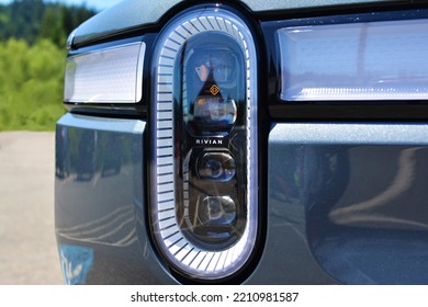 Snoqualmie, Washington - 07 25 2022: Headlight Close Up Of Rivian R1T Electric Pickup Truck. Iconic Oval Headlight Design With Light Bar