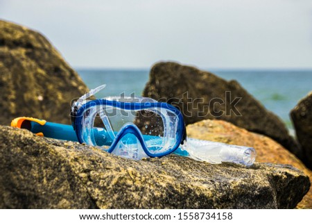 Snorkel mask on a stone at Kalutara beach in Western Province of Sri Lanka