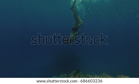 Snorkeling. The guy in the mask and tube floats in the sea