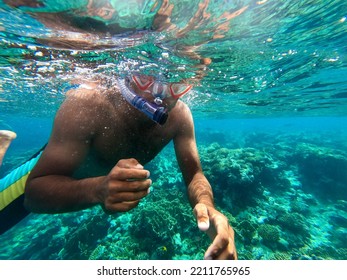 Snorkeling Young Man With Mask And Snorkel Underwater In The Sea With Clear Water. High Quality Photo