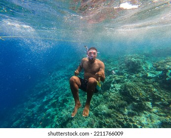 Snorkeling Young Man With Mask And Snorkel Underwater In The Sea With Clear Water. High Quality Photo