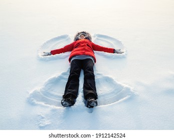 Snow Angel Made By A Happy Woman In The Snow. Top Flat Overhead View.