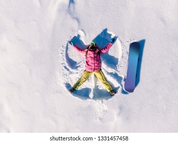 Snow Angel Snowboarder Doing Winter In Bright Suit. Aerial Top View.