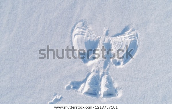 Snow\
angel\'s print on a snowcovered area. Aerial\
foto.