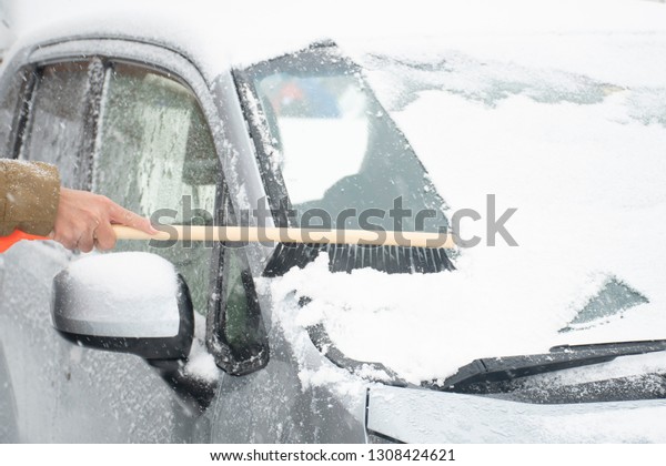 Snow blocked the car\'s window not good\
for driving by people is showing how to remove\
it.
