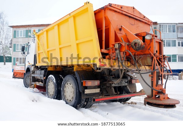 snow blower with\
bucket, brush and device for sprinkling roads close up, concept of\
cleaning roads from snow