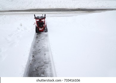 Snow Blower Removing Snow On The Driveway