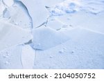 Snow and broken ice on a frozen lake surface, natural winter background photo