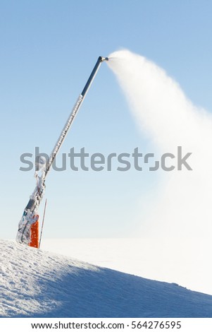 Snow cannon making artificial powder at the top of a ski slope