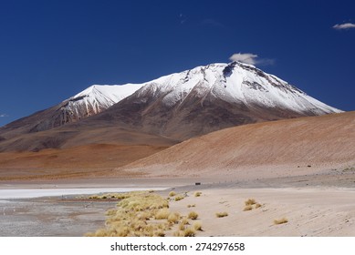 snow cap mountain in high altitude atacama desert in bolivia with lagoon - Powered by Shutterstock