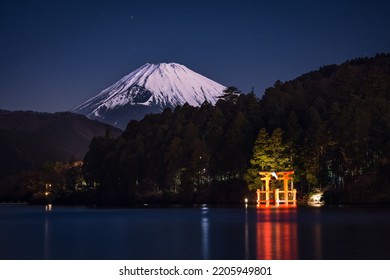 Snow Capped Mount Fuji At Night With Torii Gate From Lake Ashi Hakone Japan