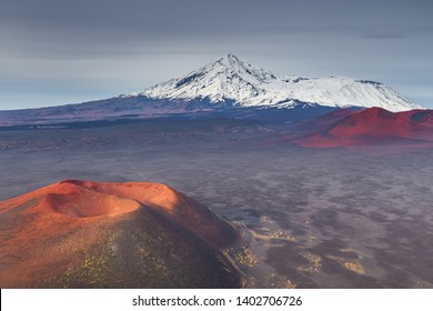 Snow- capped Mount Ostry Tolbachik, the highest point of volcanic complex on the Kamchatka Peninsula in the far east of Russia. Unnamed, extinct volcano in the first plan. - Shutterstock ID 1402706726