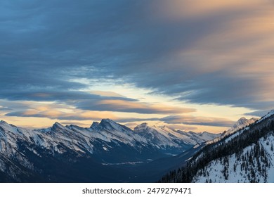 Snow capped Mount Rundle mountain range in beautiful dusk. Sky of red pink clouds in the background. Banff National Park in winter, Canadian Rockies. Beautiful nature scenery. - Powered by Shutterstock