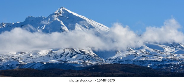 Snow capped mountain with clouds