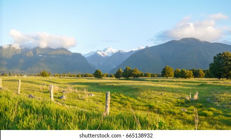 Snow Capped Mountain And Farm In New Zealand