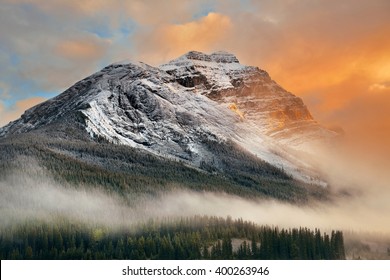 Snow capped mountain and fog at sunset in Yoho National Park in Canada - Powered by Shutterstock