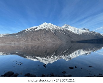 Snow capped mountain reflection in Glacier Lake, Glacier National Park, Montana - Powered by Shutterstock