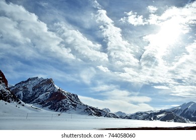   snow capped mountain under dramatic overcast sky. in Tajikistan