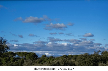 Snow capped mountains under dramatic blue sky