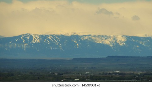 the snow capped rocky mountains as seen from Billings, Montana