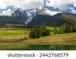 Snow capted mountain peaks by the beautiful lake in Slovakia Tatra