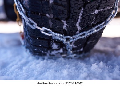 snow chain on a wheel in deep snow in winter road