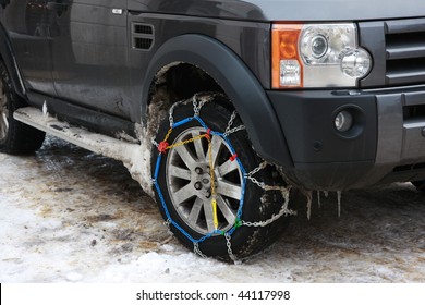 Snow Chains Fitted To A 4x4 Car.