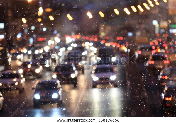 Snow in the city\
night traffic road\
transport
