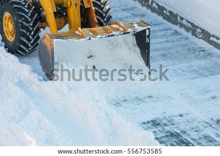  Snow clearing. Tractor clears the way after heavy snowfall.