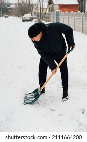 Snow Collapse. Senior Man Cleaning Snow At Winter Weather With A Shovel On A Yard During The Cold Day. Winter Trouble Concept