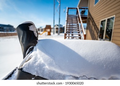 Snow Covered BBQ Smoker Grill In The Backyard With Winter Background