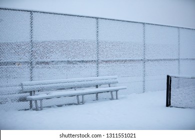 Snow Covered Bleacher Bench On A Tennis Court, In A Delayed Sporting Event Concept, With Space For Text On Top