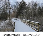 Snow covered bridge leading to a nature trail in the woods. Taken at Table Rock State Park in Missouri